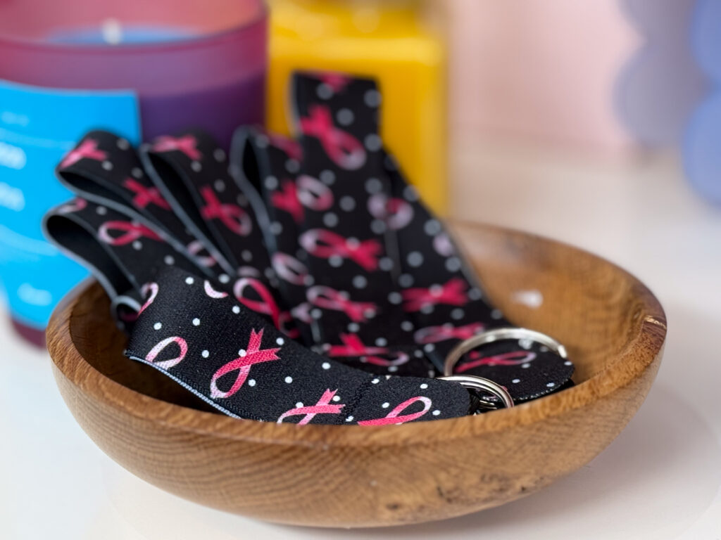 Wooden bowl of black and pink keyring.