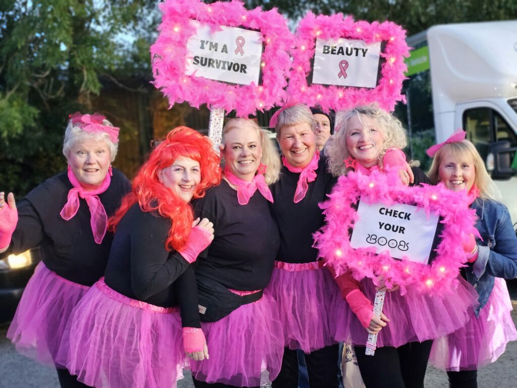 Group of woman in pink tutus and placards