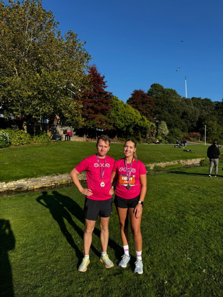 Man and woman in pink, in a field