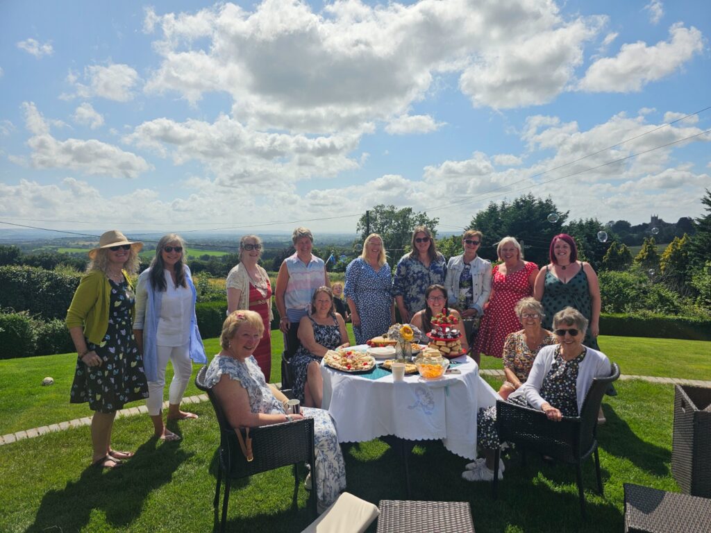group of happy ladies enjoying an afternoon tea